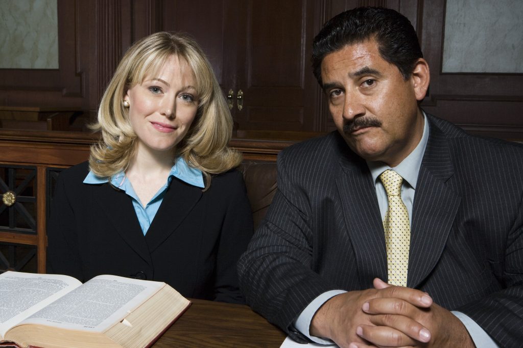 Man and woman sitting in court, portrait